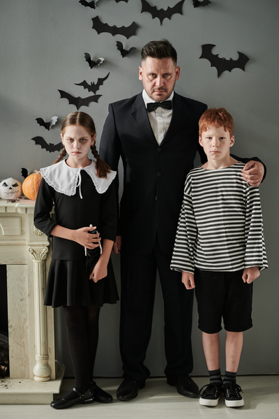 Man with His Children in Halloween Costumes